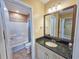 Well-lit bathroom with a dark granite vanity, tiled floors, and tub-shower combination at 122 Hartland Dr. # 11-D, Myrtle Beach, SC 29572