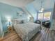 Bright bedroom featuring light blue walls, coastal artwork, a ceiling fan, and hardwood floors at 122 Hartland Dr. # 11-D, Myrtle Beach, SC 29572