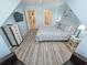 Charming blue bedroom with a queen bed, modern dresser, hardwood floors, and TV at 122 Hartland Dr. # 11-D, Myrtle Beach, SC 29572