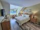 Cozy bedroom with hardwood floors, a comfortable bed, and ample natural light at 122 Hartland Dr. # 11-D, Myrtle Beach, SC 29572