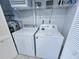 Convenient laundry room featuring a washer and dryer, with overhead storage and utility connections at 122 Hartland Dr. # 11-D, Myrtle Beach, SC 29572