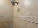 Close-up of a shower featuring tiled walls with decorative trim and a rainfall shower head at 122 Hartland Dr. # 11-D, Myrtle Beach, SC 29572