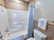 Close-up of bathroom shower featuring white tiles and a blue shower curtain at 122 Hartland Dr. # 11-D, Myrtle Beach, SC 29572