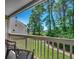 Covered balcony with chairs overlooking green space and mature trees at 1095 W Plantation Dr. W # 28D, Little River, SC 29566
