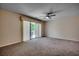 Large bedroom featuring neutral carpet, a ceiling fan, and sliding glass doors at 1095 W Plantation Dr. W # 28D, Little River, SC 29566