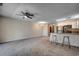 Open floor plan connecting kitchen and living room with neutral walls and ceiling fan at 1095 W Plantation Dr. W # 28D, Little River, SC 29566