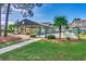 Pool area surrounded by a chain-link fence, tropical plants, trees, and lawn at 1095 W Plantation Dr. W # 28D, Little River, SC 29566