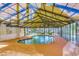 Indoor pool with orange floor and yellow metal frame ceiling and wall to wall windows offering natural light and views at 1095 W Plantation Dr. W # 28D, Little River, SC 29566