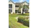 Attractive exterior of a two-story building with landscaping and a pond at 8925 Duckview Dr. # A, Myrtle Beach, SC 29575