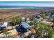 Aerial view of home showcasing proximity to beach, coastal landscape and wetlands at 189 Brown Pelican Loop, Pawleys Island, SC 29585