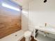 Bathroom with a stand up shower featuring wood tile, modern sink, and faucet with a large window for natural light at 189 Brown Pelican Loop, Pawleys Island, SC 29585
