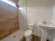 Elegant bathroom with a walk-in shower featuring natural wood tile and a modern sink and faucet at 189 Brown Pelican Loop, Pawleys Island, SC 29585