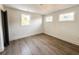 Simple bedroom with three windows and wood-look flooring at 189 Brown Pelican Loop, Pawleys Island, SC 29585