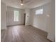 Bright bedroom featuring a modern ceiling fan, wood floors, and natural light from the windows at 189 Brown Pelican Loop, Pawleys Island, SC 29585