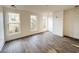 Bright bedroom with three windows and wood-look flooring at 189 Brown Pelican Loop, Pawleys Island, SC 29585