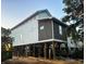 Elevated home with white and dark gray siding, under construction at 189 Brown Pelican Loop, Pawleys Island, SC 29585