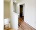 Hallway featuring stairs, modern design, and hardwood floors leading to a bedroom with a modern door at 189 Brown Pelican Loop, Pawleys Island, SC 29585