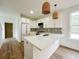 Bright kitchen featuring white cabinets, quartz countertops, gold hardware, mosaic tile backsplash, and modern appliances at 189 Brown Pelican Loop, Pawleys Island, SC 29585