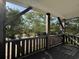 View from porch featuring brown wood posts, beams, railings and trees at 189 Brown Pelican Loop, Pawleys Island, SC 29585
