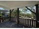 View from the porch featuring brown wood posts and railings overlooking trees at 189 Brown Pelican Loop, Pawleys Island, SC 29585