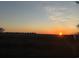 Scenic sunset view over distant homes and marsh at 189 Brown Pelican Loop, Pawleys Island, SC 29585