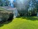 Spacious backyard featuring lush green grass and mature shade trees at 412 Callie Dr., Myrtle Beach, SC 29588