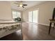 Bright bedroom with wood-look floors, ceiling fan, and sliding glass doors at 412 Callie Dr., Myrtle Beach, SC 29588