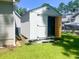 White storage shed with double doors, providing ample outdoor storage space at 412 Callie Dr., Myrtle Beach, SC 29588
