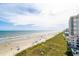 Stunning aerial view of the beach, shoreline, and condos with easy ocean access and sunny skies at 5800 N Ocean Blvd. # 705, North Myrtle Beach, SC 29582