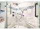 Modern bathroom shower featuring sleek black fixtures, patterned accent tiles, and a convenient built-in seat at 5800 N Ocean Blvd. # 705, North Myrtle Beach, SC 29582