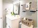 Well-lit bathroom features white vanity with black fixtures, decorative towels, and a storage basket at 5800 N Ocean Blvd. # 705, North Myrtle Beach, SC 29582