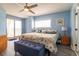 Spacious bedroom with ceiling fan, balcony access, and blue accent pillows, all with an ocean view at 5800 N Ocean Blvd. # 705, North Myrtle Beach, SC 29582