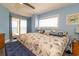 Bright and cozy bedroom boasts balcony access with ocean views and a king bed at 5800 N Ocean Blvd. # 705, North Myrtle Beach, SC 29582