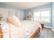 Inviting bedroom with wood-look flooring, complemented by large windows and a coastal-themed comforter at 5800 N Ocean Blvd. # 705, North Myrtle Beach, SC 29582
