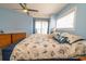 Comfortable bedroom with balcony access and ocean view, featuring a king size bed and a ceiling fan at 5800 N Ocean Blvd. # 705, North Myrtle Beach, SC 29582
