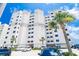 Stunning exterior view of a multi-story condo building with palm trees in front at 5800 N Ocean Blvd. # 705, North Myrtle Beach, SC 29582