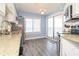 Bright kitchen with granite countertops, stainless appliances, and a sliding door that leads to a balcony at 5800 N Ocean Blvd. # 705, North Myrtle Beach, SC 29582