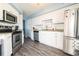 Well lit kitchen offers stainless steel appliances and lots of white cabinets for ample storage at 5800 N Ocean Blvd. # 705, North Myrtle Beach, SC 29582