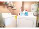 Functional laundry room with a washer, dryer, storage shelves, and essential laundry supplies at 5800 N Ocean Blvd. # 705, North Myrtle Beach, SC 29582