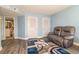 Comfortable living room with a gray couch, colorful rug, and view into a bathroom at 5800 N Ocean Blvd. # 705, North Myrtle Beach, SC 29582
