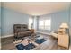 Bright living room with windows showcasing city views, a comfortable recliner, and stylish blue accents at 5800 N Ocean Blvd. # 705, North Myrtle Beach, SC 29582