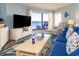 Bright living room with ocean view, comfy furniture, and beach-themed decor at 5800 N Ocean Blvd. # 705, North Myrtle Beach, SC 29582