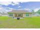 Spacious backyard featuring well-maintained lawn, an outdoor patio, and the home's rear exterior at 252 Timber Run Dr., Georgetown, SC 29440