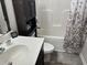 A modern bathroom with black cabinets, a sink, toilet, and shower/tub combination at 252 Timber Run Dr., Georgetown, SC 29440