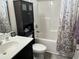 A modern bathroom with black cabinets, a sink, toilet, and shower/tub combination at 252 Timber Run Dr., Georgetown, SC 29440