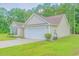 A single-story home with an attached garage, well-maintained lawn, and lush landscaping at 252 Timber Run Dr., Georgetown, SC 29440