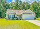 Attractive single-story home with a manicured lawn, an attached garage, and pleasing curb appeal at 252 Timber Run Dr., Georgetown, SC 29440