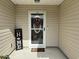 Cozy front porch entrance with a decorative wreath and a welcoming 'Home' sign at 252 Timber Run Dr., Georgetown, SC 29440