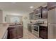 Modern kitchen with stainless steel appliances, dark cabinets, and a clear view of the dining area at 252 Timber Run Dr., Georgetown, SC 29440