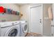 Laundry room with Samsung washer and dryer, shelf with storage baskets, and a door to the outside at 252 Timber Run Dr., Georgetown, SC 29440